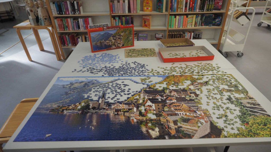 Puzzeln - Ein fast fertiges Puzzle in der Pasila-Bibliothek, der Hauptfiliale der Stadtbibliothek Helsinki in Pasila, Helsinki, Finnland.